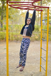 Girl playing at jungle gym