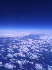 Aerial view of clouds over sea against blue sky