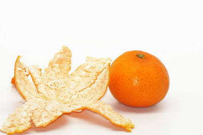 Close-up of orange fruits on white background