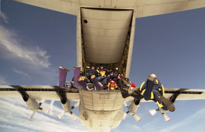 Low angle view of men against built structure