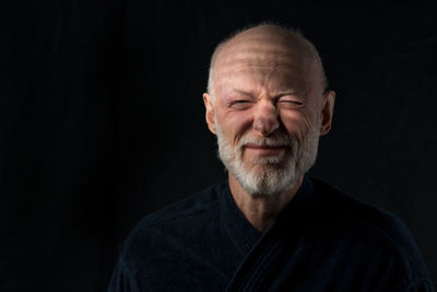 Portrait of man against black background