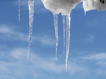 Transparent icicles of ice against the blue sky