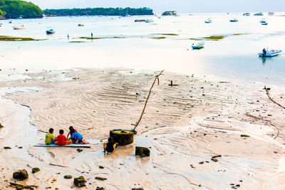 High angle view of people sitting on beach