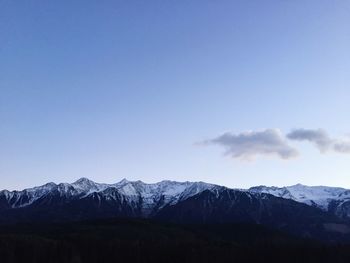 Scenic view of mountains against blue sky