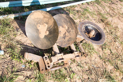 High angle view of old rusty metal on field