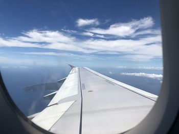 Aerial view of aircraft wing seen through glass window