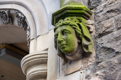 Low angle view of statue against building