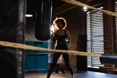 Rear view of woman exercising in gym