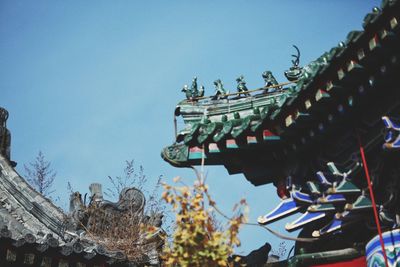 Low angle view of temple against blue sky