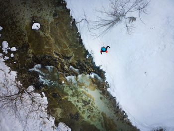 High angle view of person on snowcapped mountain during winter