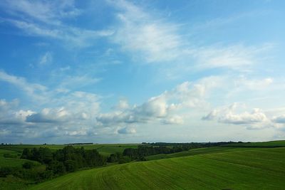 Scenic view of field against cloudy sky