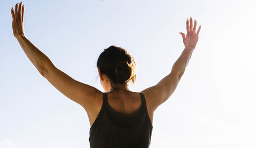 Woman raising her arms