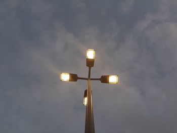 Low angle view of illuminated street light against sky at night