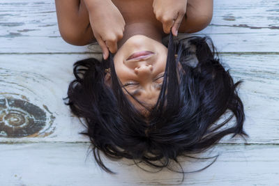 Midsection of woman lying down with eyes closed