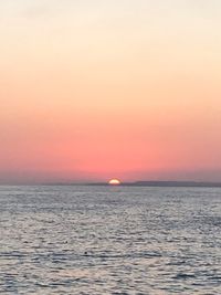 Scenic view of sea against romantic sky at sunset