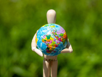 Close-up of figurine with globe