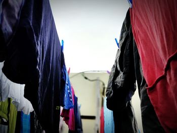 People standing on clothesline against sky