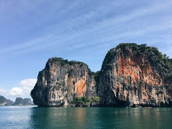 Rock formations in sea against sky