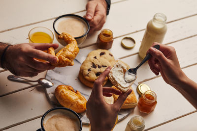 High angle view of people preparing food on table