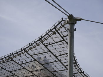 Low angle view of telephone pole against sky