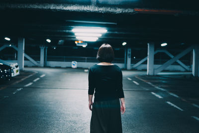 Rear view of woman walking on bridge