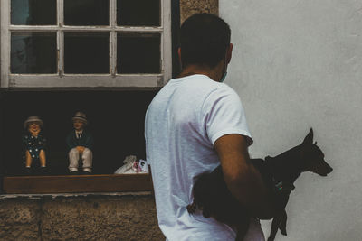 Rear view of man statue against window