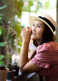 Portrait of a smiling young woman looking away