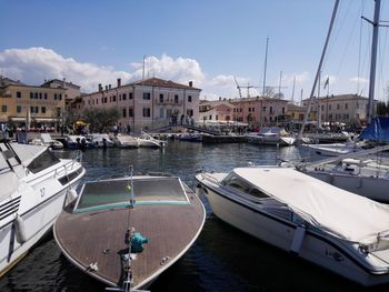 Sailboats moored at harbor