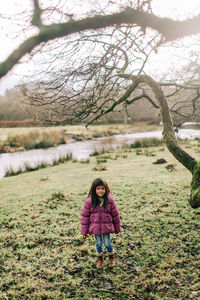 Portrait of woman standing on field