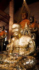 Low angle view of buddha statue at night