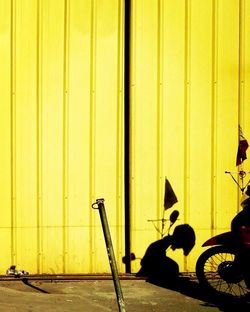 Bicycle against yellow wall