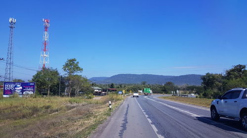 Road against clear blue sky