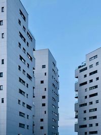 Low angle view of modern buildings against clear blue sky