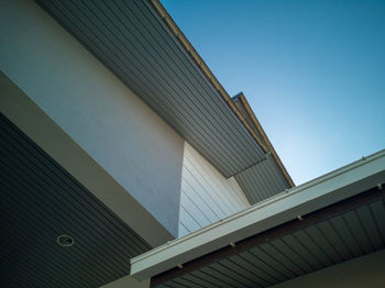Low angle view of modern building against clear blue sky