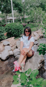 Woman sitting on rock