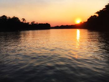 Scenic view of lake against sky during sunset