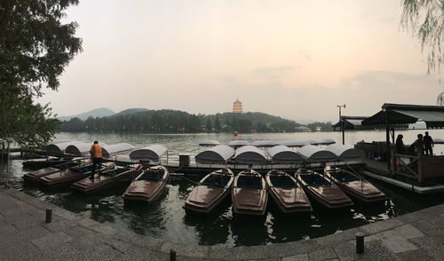 Panoramic view of boats moored in river