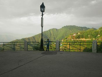 View of street light against cloudy sky