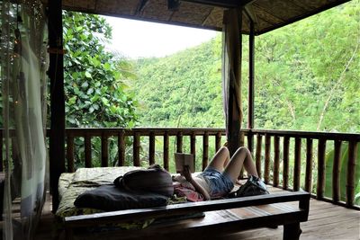 Low section of woman sitting outdoors