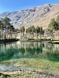 Scenic view of lake and mountains against sky