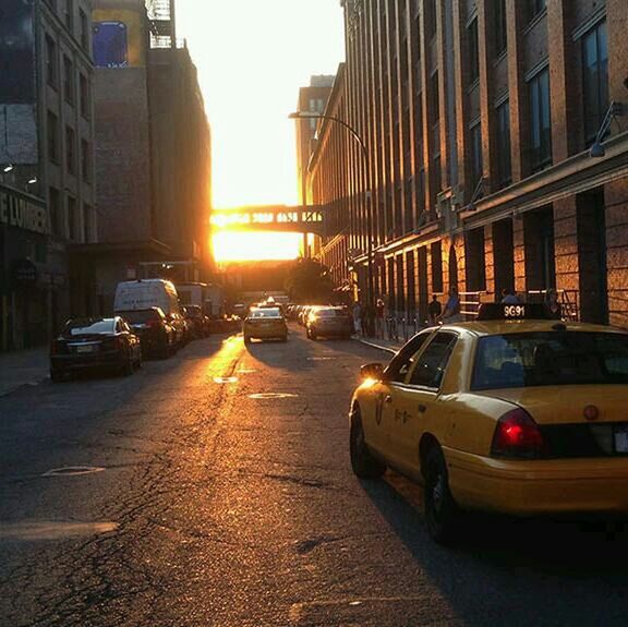 transportation, car, mode of transport, land vehicle, architecture, building exterior, built structure, sunset, city, street, sun, traffic, sunlight, road, city life, city street, sunbeam, building, on the move, lens flare