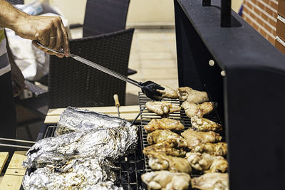 Spicy chicken wings grilling on a summer barbecue