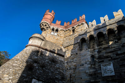 Low angle view of fort against blue sky