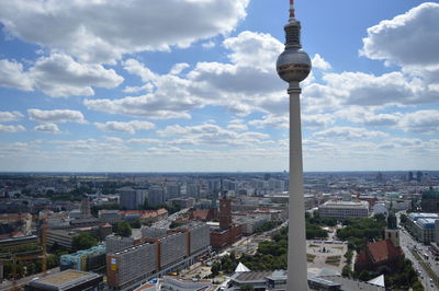 View of cityscape against cloudy sky