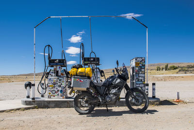 Adventure motorcycle parked at petrol station in remote area