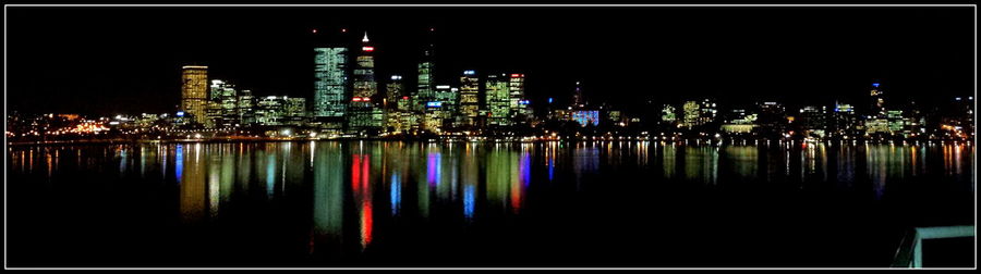 Reflection of illuminated buildings in water at night