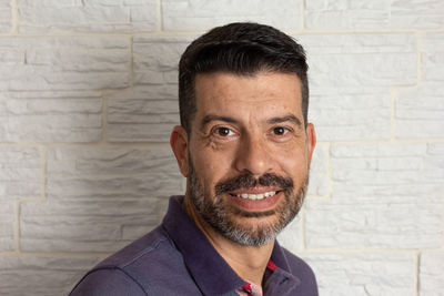 Portrait of smiling man against wall