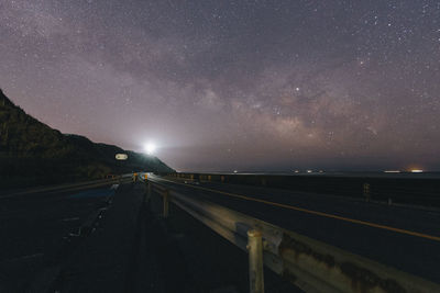 Road against sky at night