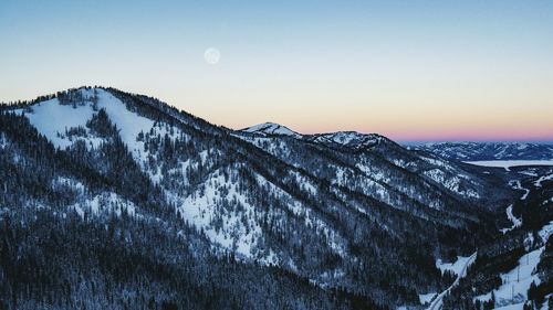 Close-up of snowcapped mountain against sky during sunset