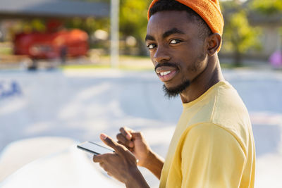 Side view of young woman using mobile phone